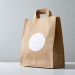 Paper Bag with Round Sticker Mockup Label on White Table for Branding Promotion